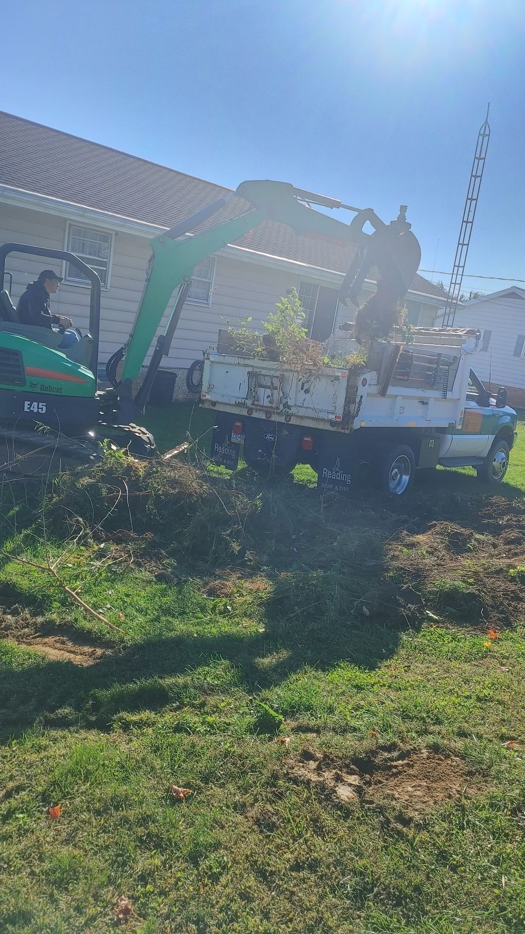 Dump truck loaded with cleared brush and stumps ready for haul-away