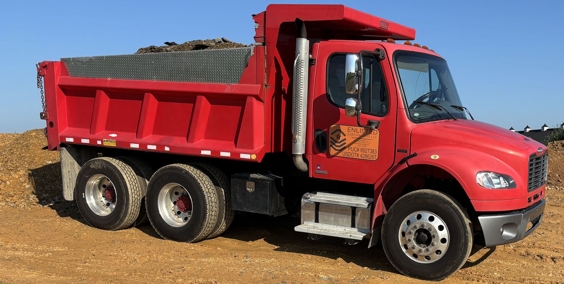 Dump truck hauling debris off a job site