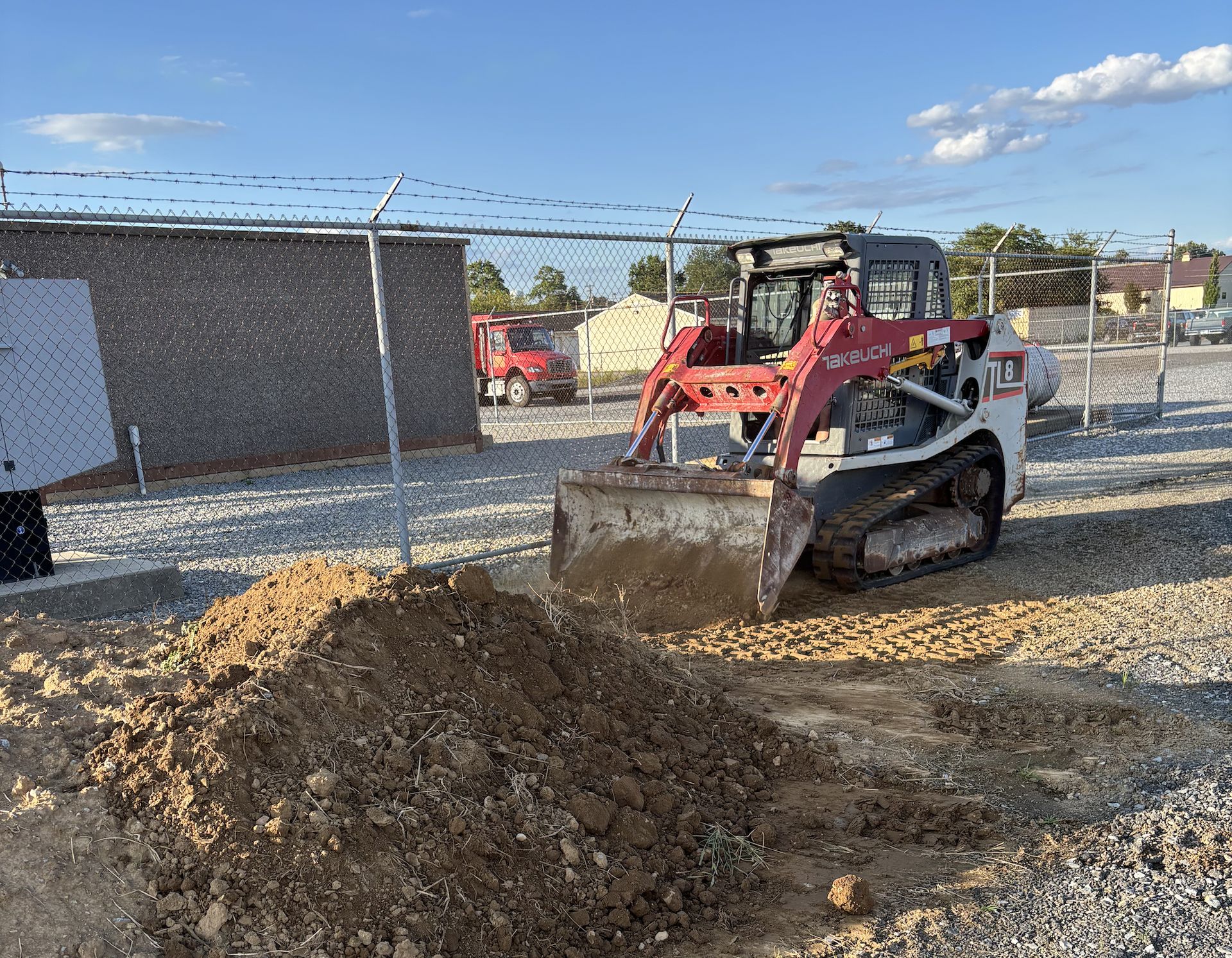 Skid steer performing land clearing work